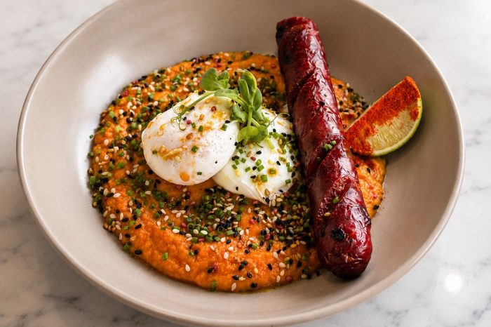 Rustic brunch with poached eggs, beef sausage and sweet potato purée at L’Amiral in Plaka, Athens